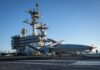 The successful testing onboard an active Navy aircraft carrier is a win for the high-profile program under pressure to stay on schedule