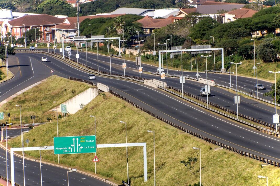 Morning landscape close up of empty M41 freeway with on and off ramps passing through urban buildings in Mhlanga Ridge in Durban, South Africa