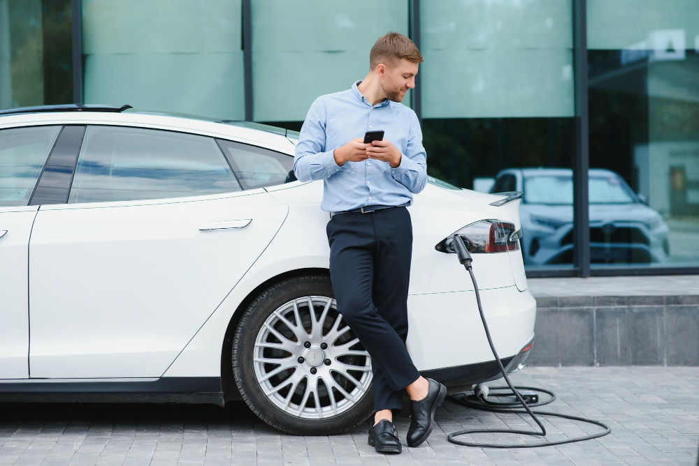 man-charges-electric-car-charging-station