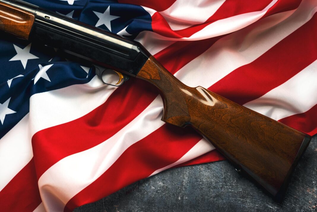 Shotgun over American Flag. Gun control and rights