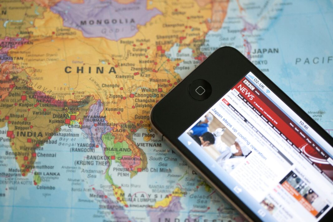apple iphone lying on map of China