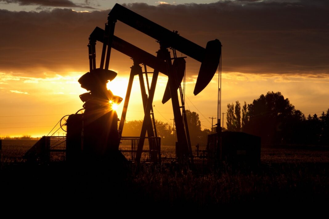 Silhouette of oil wells at sunset